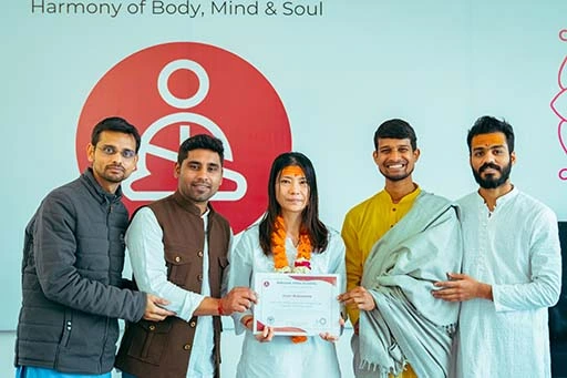 Joan Nakazono with her 200-Hour Yoga TTC Certification at Nirvana Yoga School Rishikesh
